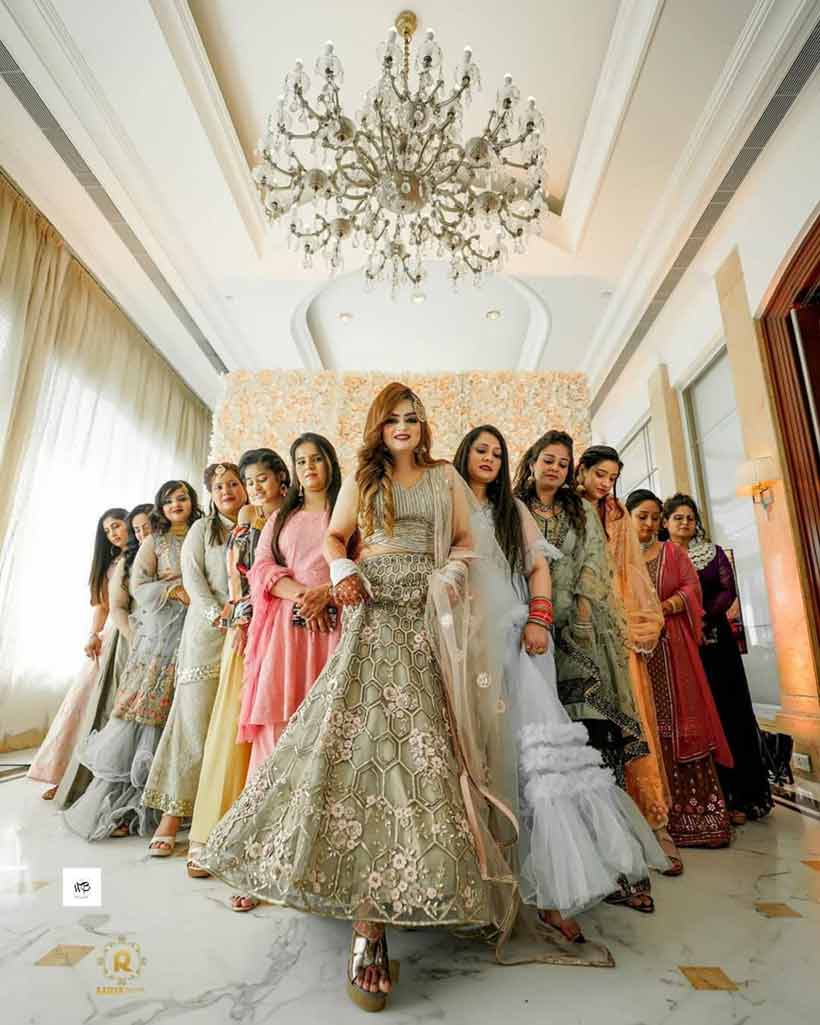 a woman in traditional indian attire poses for a photo with her bridesmaids.  AI-Generated 32558989 Stock Photo at Vecteezy